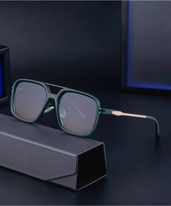 Detail of retro square frame sunglasses with green translucent finish and gold accents