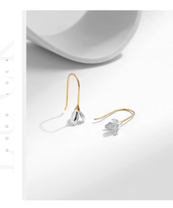 Detail of S925 sterling silver magnolia petal earrings with silver and gold contrast