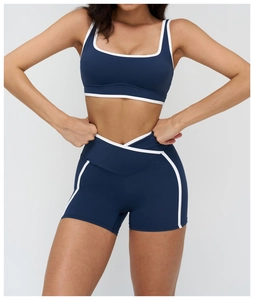 Navy blue yoga set detail with white contrast binding and v-waist cross gym shorts