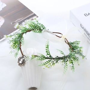 Detail of floral crown with white daisies, brown vine base and vintage silver pendant