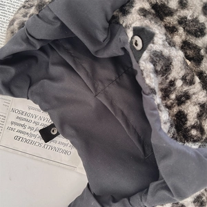 Macro detail of the plush faux fur leopard pattern tote with inner lining and metal snap