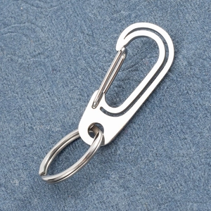 Close-up of a heavy-duty stainless steel carabiner keychain on a blue background