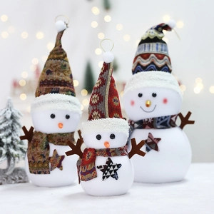 Three plush Christmas snowmen with knitted hats and scarves for festive home decoration