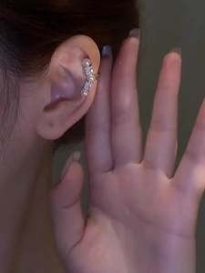 Detailed view of silver ear cuff with white pearls and sparkling cubic zirconia stones