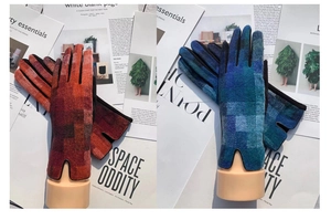 Close-up of warm winter plaid gloves in red and blue gradient knit with touchscreen tips