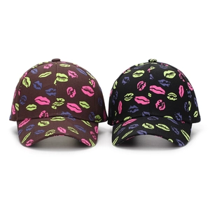 Detail of cotton baseball caps with colorful all-over lip print pattern and curved brim