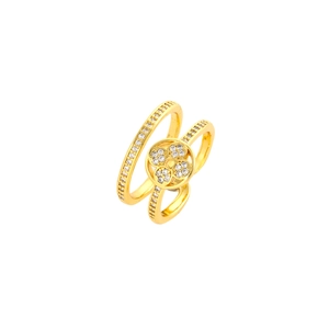 Detail of a gold double-layer ring with sparkling white zircons and hollow clover flower