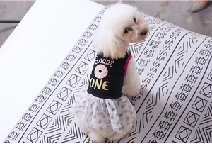Close-up of dog dress featuring pink donut print and tiered star-patterned mesh skirt