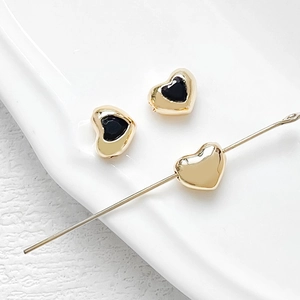 Macro shot of heart-shaped 18k gold plated beads with zircon for DIY jewelry making