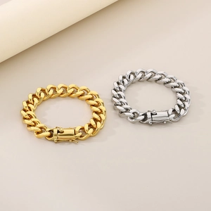 Detail view of 13mm gold and silver Cuban link bracelets with secure fold-over clasps