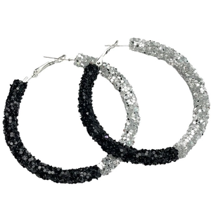 Detail of oversized black and silver glitter hoop earrings with shiny sequins finish
