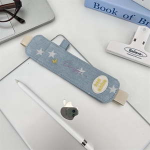 Detail of light blue denim stylus pouch with elastic band and star embroidery