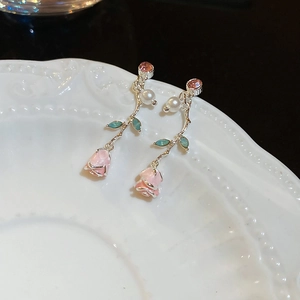 Detail of pink enamel rose earrings with silver vine, blue leaves and pearl accents
