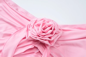 Detailed view of the bright pink 3D floral decoration on high-elastic knitted fabric