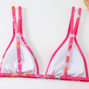 Detailed view of floral bikini top with metal buckle closure and white mesh lining