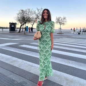 Elegant green chiffon maxi dress with puff sleeves and cut-out detail in floral print