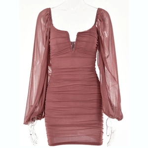 Detail view of ruched dark pink mesh dress featuring deep V-neckline and lantern sleeves