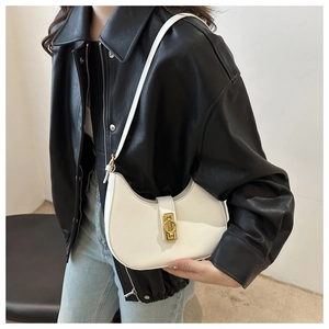 Detail view of the white leather hobo bag with a prominent golden metallic buckle