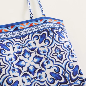 Detail of Mediterranean majolica blue print on swimsuit with orange trim detailing