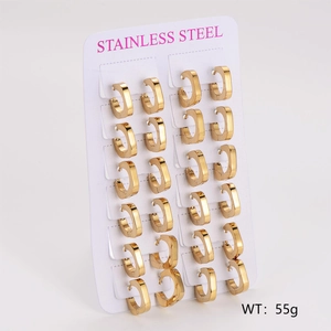 Macro view of twelve pairs of polished gold stainless steel square hoop earrings on a card