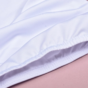 Detailed close-up of white knitted fabric edges with delicate wave lace and scallop trim
