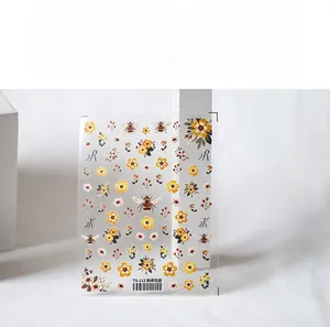 Macro detail of 5D floral embroidery nail stickers with bee patterns and vintage flowers
