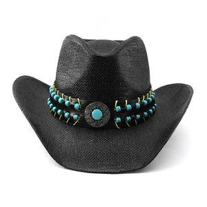 Close-up of black straw cowboy hat with turquoise beads and vintage silver metal buckle