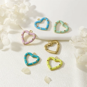 Detailed view of colorful heart enamel pendants with sparkling micro-inlaid gemstones