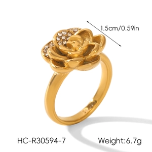 Close-up of 18k gold plated rose ring with sparkling white crystal petals and engraved band