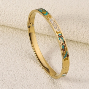 Close-up of 18K gold-plated steel bangle with colorful enamel floral painting details