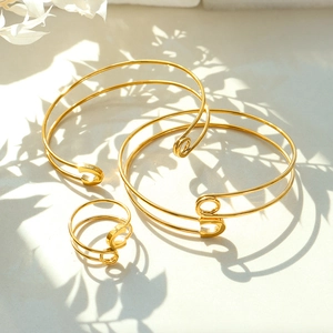 3-piece gold safety pin jewelry set featuring two bracelets and one ring in minimalist style