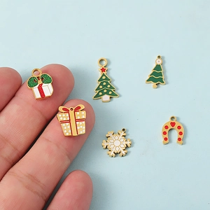 Christmas charms set featuring gold plated 18K enamel reindeer and tree pendants