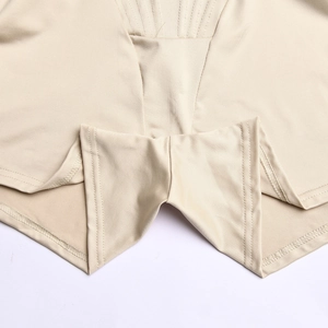 Detail shot of beige bodysuit crotch with precise stitching and elastic smooth fabric