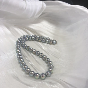 Silver-blue round Akoya-style pearl necklace on white silk fabric with S925 silver clasp