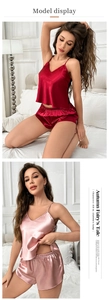 Detailed view of red and pink satin loungewear set with delicate lace and V-neckline
