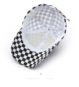 Detail view of checkerboard baseball cap showing 100% cotton inner lining and wash label