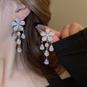 Elegant zircon flower earrings with silver needle and tassel teardrops on model