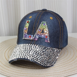 Detail showing denim baseball cap with rhinestone brim and rainbow LA patch