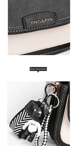 Detail of color-block leather crossbody bag with metal logo and bear charm accessory