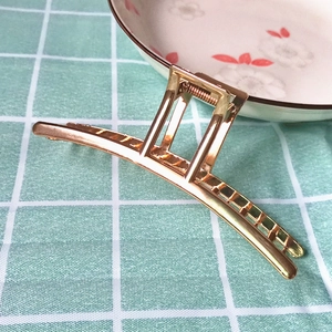 Minimalist large golden metal claw clip for women featuring a sleek hollow frame design