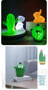 Detail of cute LED night lights featuring cactus, white dinosaur, and orange rabbit characters