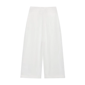 Detailed view of high-quality white wide-leg trousers with elegant flowing drape fabric