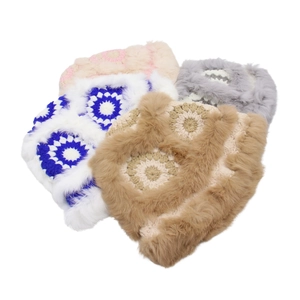 Detail of crochet bucket hats with faux fur trim in pink, blue, grey, and brown colors