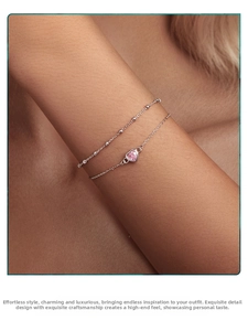 Close-up of double-layer S925 silver bracelet featuring pink heart pendant and beaded chain