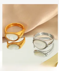 Macro detail of high-polish vintage signet rings with oval white shell inlay on satin