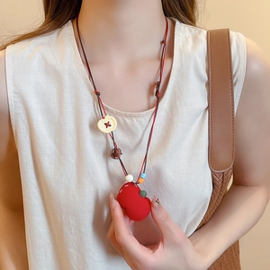 Detailed view of handmade beaded long necklace with red matte apple pendant and colorful beads
