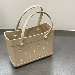 Detail view of beige EVA beach tote bag featuring laser-cut holes and white round fasteners