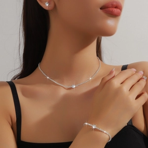 Close-up of a silver zircon necklace, earrings, and bracelet set worn by a model