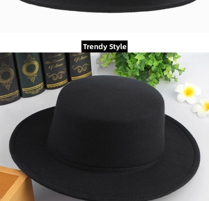 Detailed macro view of the black wool felt wide-brim hat featuring fine fabric texture