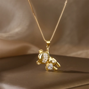 Close-up of golden bear pendant with micro-pave cubic zirconia and heart-shaped stone